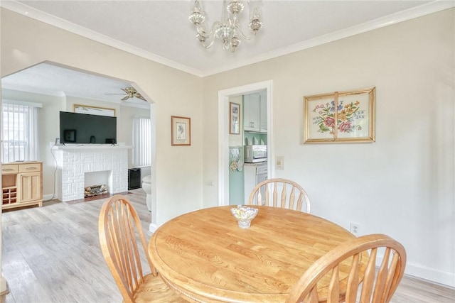 350 Colebourne Rd, Rochester, NY 14609 - dining space featuring light wood-style flooring, a ceiling fan, crown molding, a chandelier, and baseboards