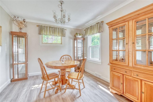 350 Colebourne Rd, Rochester, NY 14609 - dining area featuring ornamental molding, a chandelier, light wood finished floors, and healthy amount of natural light