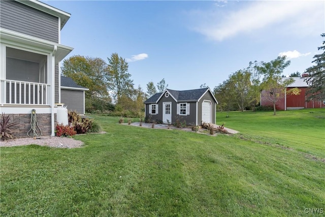32160 State Route 12e, Cape Vincent, NY 13618 - view of green lawn with an outbuilding and a garage