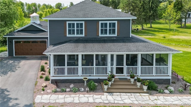 32160 State Route 12e, Cape Vincent, NY 13618 - view of front facade with a shingled roof, a sunroom, an attached garage, and asphalt driveway