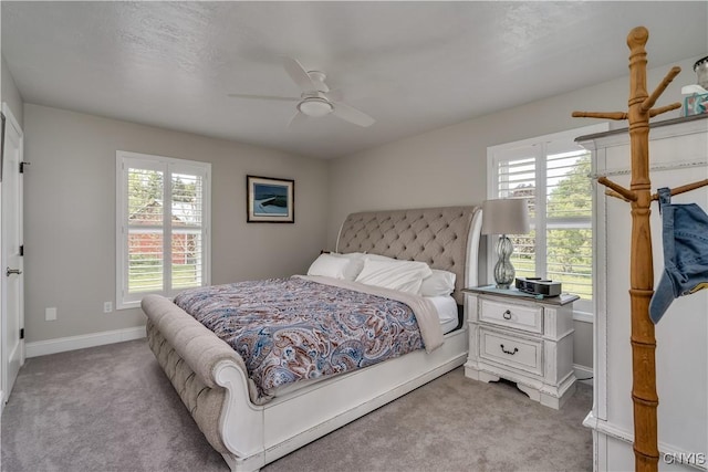 32160 State Route 12e, Cape Vincent, NY 13618 - bedroom with light colored carpet, multiple windows, a ceiling fan, and baseboards