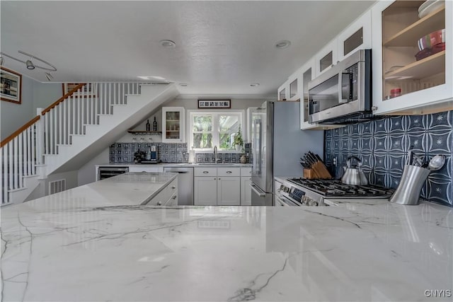32160 State Route 12e, Cape Vincent, NY 13618 - kitchen with stainless steel appliances, light stone counters, tasteful backsplash, and a sink