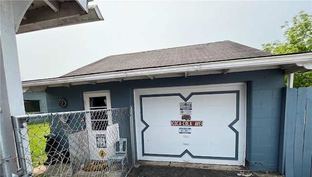 1214 S Main, Southport, NY 14904 - property entrance featuring concrete block siding, roof with shingles, and a garage