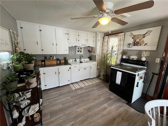 1214 S Main, Southport, NY 14904 - kitchen featuring range with electric cooktop, a ceiling fan, light wood-style floors, and white cabinetry