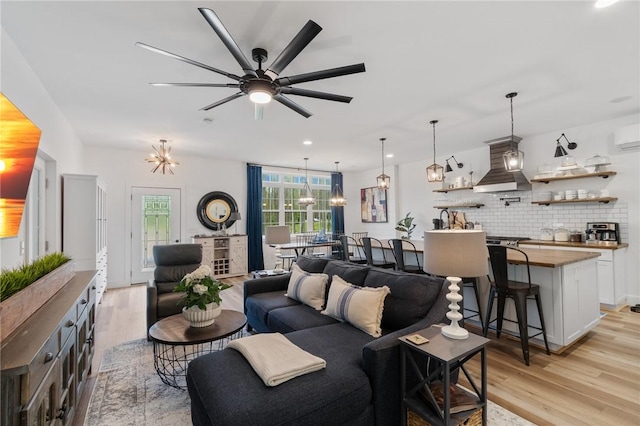 7698 Ridge Rd, Sodus, NY 14551 - living room with light wood-style floors, a chandelier, a ceiling fan, a wall unit AC, and recessed lighting