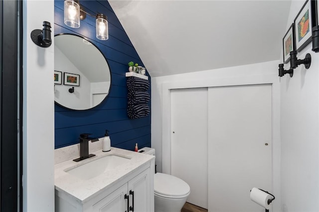 7698 Ridge Rd, Sodus, NY 14551 - bathroom with lofted ceiling, vanity, and toilet