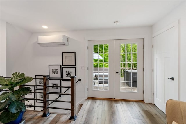7698 Ridge Rd, Sodus, NY 14551 - doorway with a wall mounted AC, french doors, wood finished floors, and recessed lighting