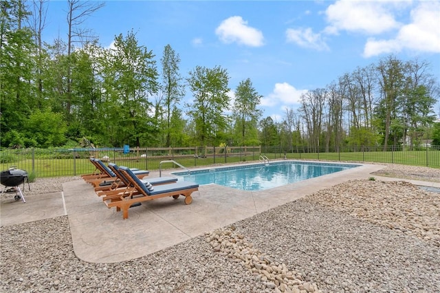 7698 Ridge Rd, Sodus, NY 14551 - view of swimming pool featuring a patio, view of wooded area, and grilling area