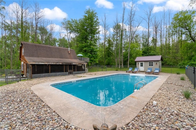 7698 Ridge Rd, Sodus, NY 14551 - view of pool featuring a fenced backyard, a patio, an outbuilding, a storage structure, and a sunroom