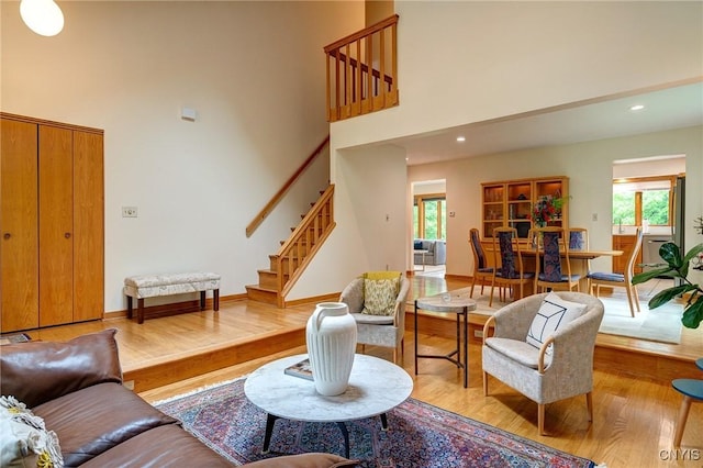 3502 Lightfoot Ln, Lysander, NY 13027 - living area featuring wood finished floors, stairway, a towering ceiling, recessed lighting, and baseboards