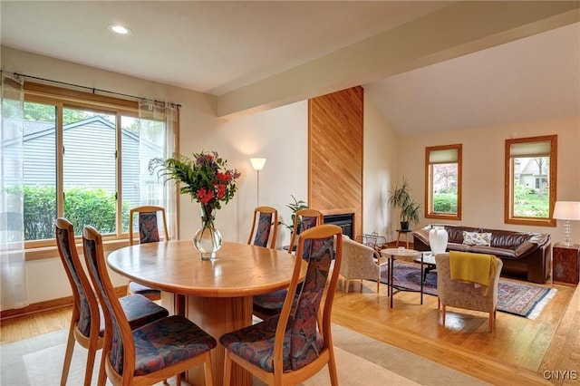 3502 Lightfoot Ln, Lysander, NY 13027 - dining room with healthy amount of natural light, light wood-style floors, recessed lighting, a fireplace, and lofted ceiling