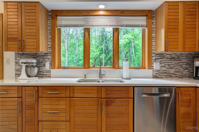 3502 Lightfoot Ln, Lysander, NY 13027 - kitchen featuring stainless steel dishwasher, a sink, light countertops, and decorative backsplash