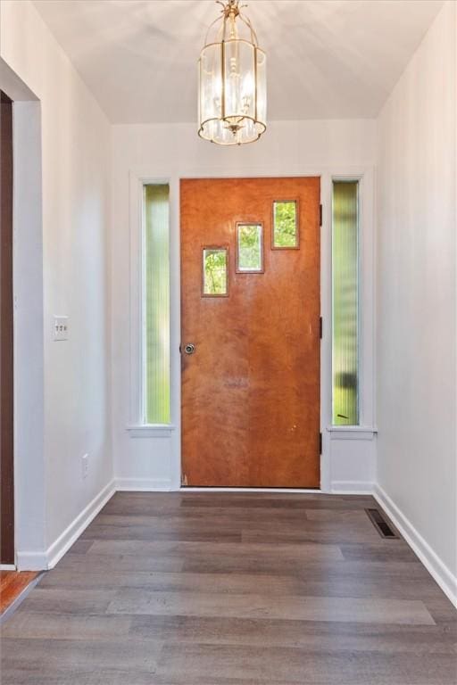 4411 Williamson Rd, Marion, NY 14505 - foyer entrance with a chandelier, wood finished floors, baseboards, and healthy amount of natural light