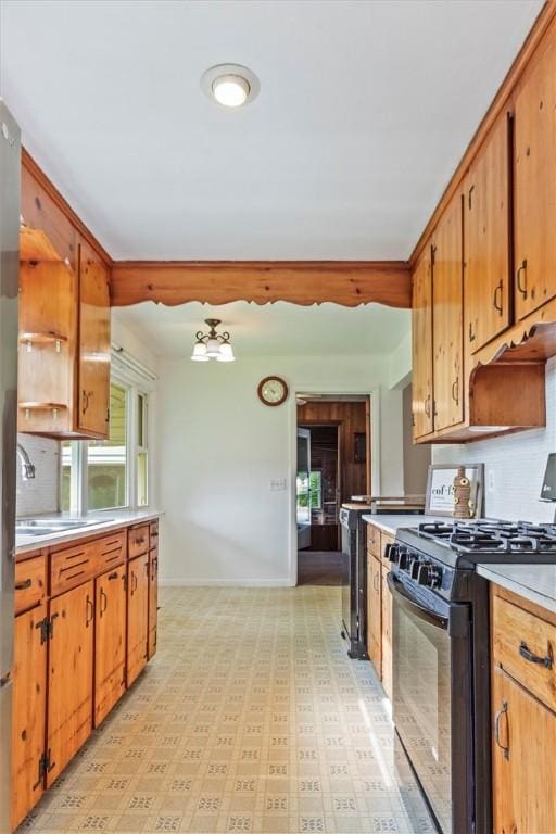 4411 Williamson Rd, Marion, NY 14505 - kitchen with black range with gas cooktop, light countertops, a sink, baseboards, and light floors