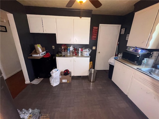 1563 Norton St, Rochester, NY 14621 - kitchen featuring stainless steel microwave, a ceiling fan, white cabinetry, a sink, and dark wood-style floors