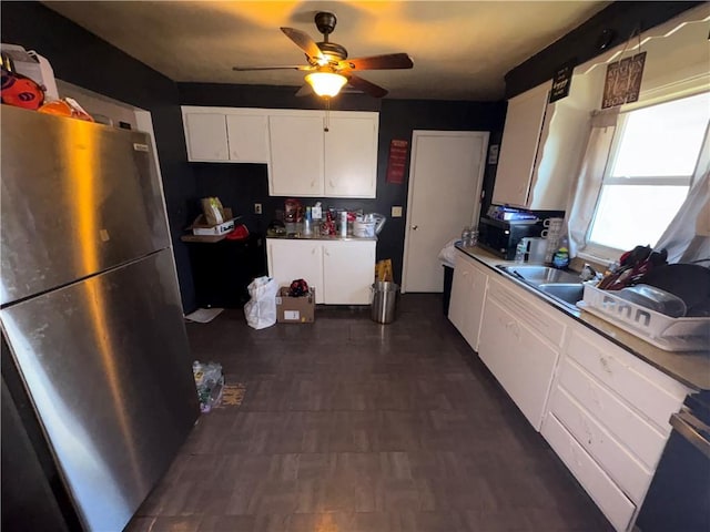 1563 Norton St, Rochester, NY 14621 - kitchen featuring freestanding refrigerator, ceiling fan, white cabinets, and stove