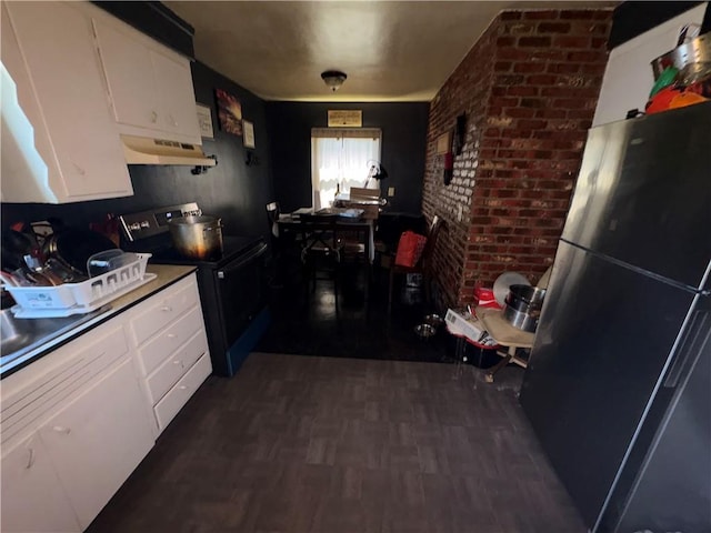 1563 Norton St, Rochester, NY 14621 - kitchen with range with electric stovetop, freestanding refrigerator, under cabinet range hood, white cabinets, and dark wood-style flooring