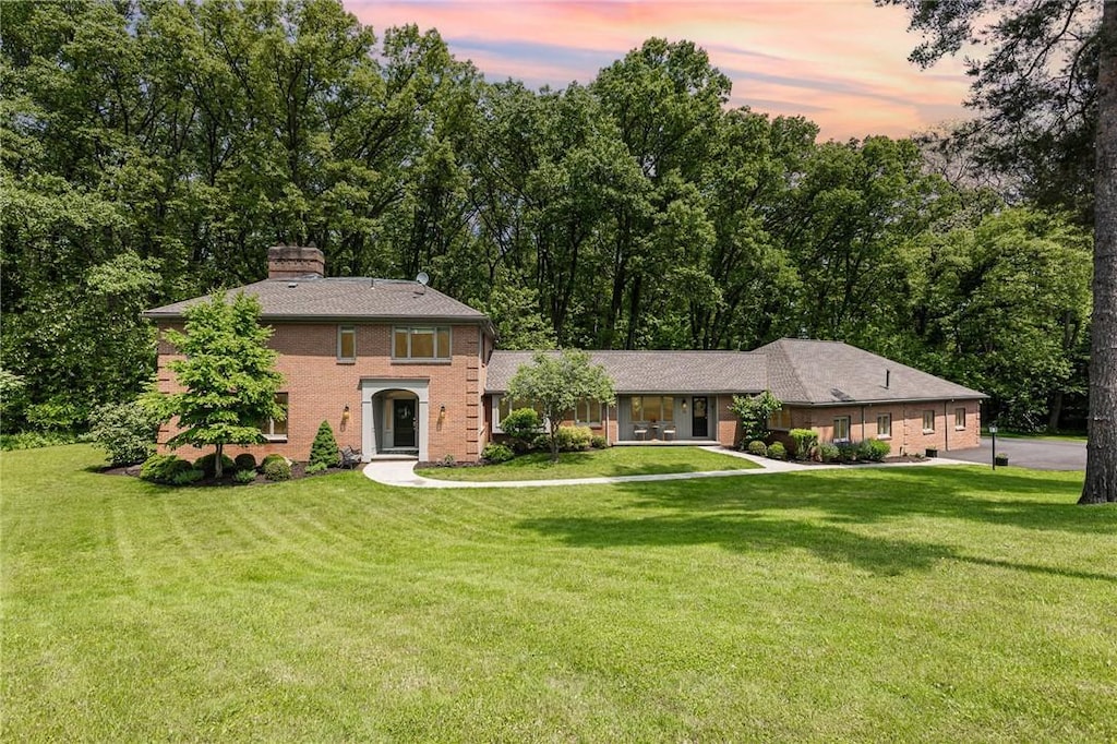 16 Landsdowne Ln, Pittsford, NY 14618 - view of front of property featuring a front yard, a chimney, and brick siding