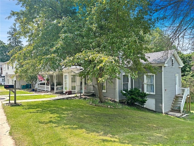4 Park Rd W, Castile, NY 14427 - view of front of home featuring a front lawn, a porch, and a shingled roof