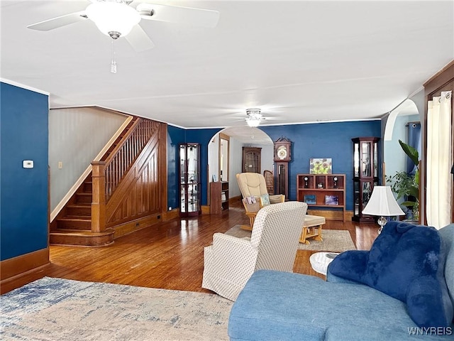 4 Park Rd W, Castile, NY 14427 - living area featuring arched walkways, a ceiling fan, stairs, and wood finished floors
