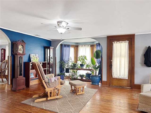 4 Park Rd W, Castile, NY 14427 - living area with arched walkways, a ceiling fan, wood finished floors, and crown molding