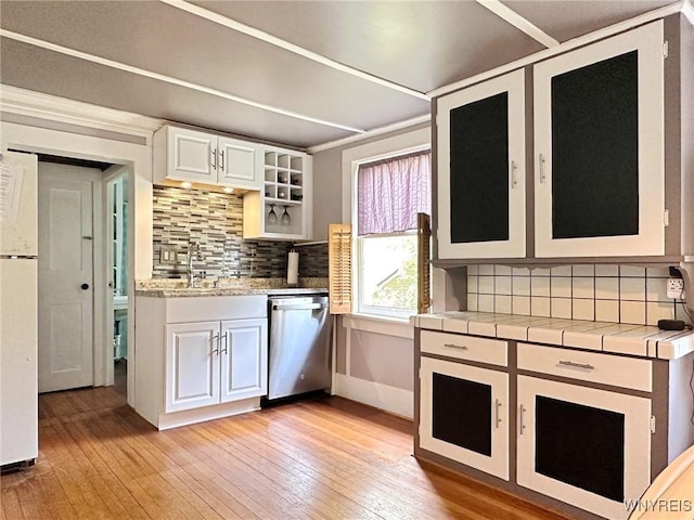 4 Park Rd W, Castile, NY 14427 - kitchen with stainless steel dishwasher, light wood finished floors, tasteful backsplash, and a sink