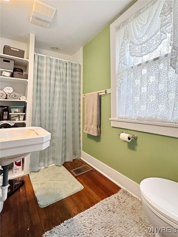 4 Park Rd W, Castile, NY 14427 - full bath featuring baseboards, wood finished floors, toilet, and curtained shower