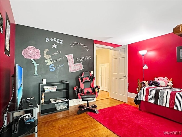 4 Park Rd W, Castile, NY 14427 - bedroom featuring wood finished floors and an accent wall