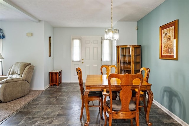 8 Harrier Cir, Henrietta, NY 14623 - dining room featuring a chandelier, baseboards, and dark stone finish floors