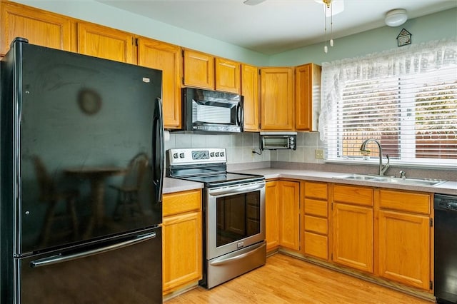 8 Harrier Cir, Henrietta, NY 14623 - kitchen with black appliances, a sink, light wood-style flooring, a ceiling fan, and light countertops