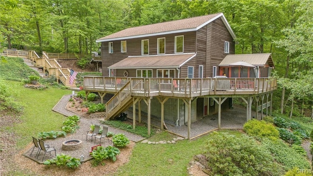 1388 Sky High Rd, Fabius, NY 13159 - back of property featuring stairs, a fire pit, a sunroom, and a deck