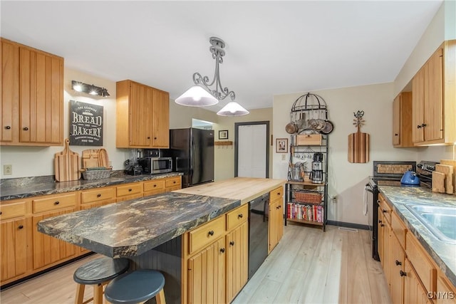 1388 Sky High Rd, Fabius, NY 13159 - kitchen with freestanding refrigerator, light wood-type flooring, electric range oven, a breakfast bar area, and a kitchen island