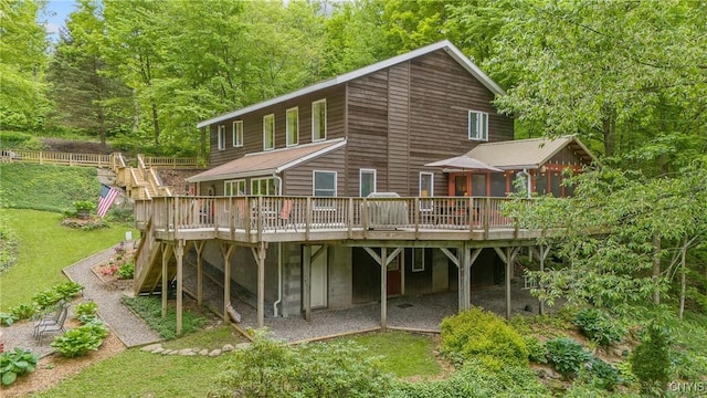 1388 Sky High Rd, Fabius, NY 13159 - rear view of property featuring a wooden deck, a sunroom, a lawn, and stairway
