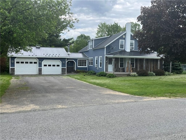 808 Fay, Bangor, NY 12966 - view of front of property featuring a chimney, a garage, a front yard, asphalt driveway, and metal roof