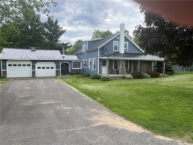808 Fay, Bangor, NY 12966 - view of front of house with an attached garage, covered porch, metal roof, driveway, and a chimney