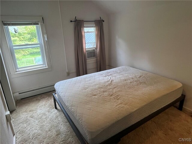 808 Fay, Bangor, NY 12966 - bedroom with a baseboard radiator, multiple windows, carpet floors, and lofted ceiling