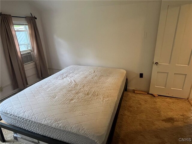808 Fay, Bangor, NY 12966 - bedroom featuring light colored carpet, cooling unit, and baseboards