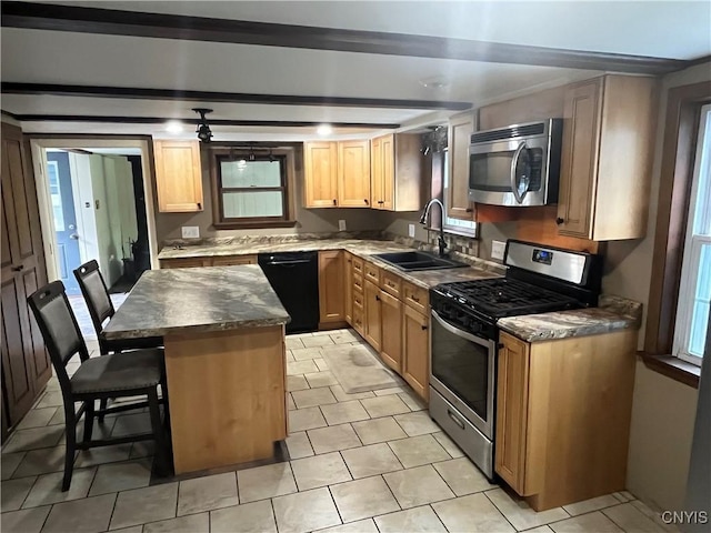 808 Fay, Bangor, NY 12966 - kitchen with stainless steel appliances, a sink, a breakfast bar area, a center island, and dark countertops