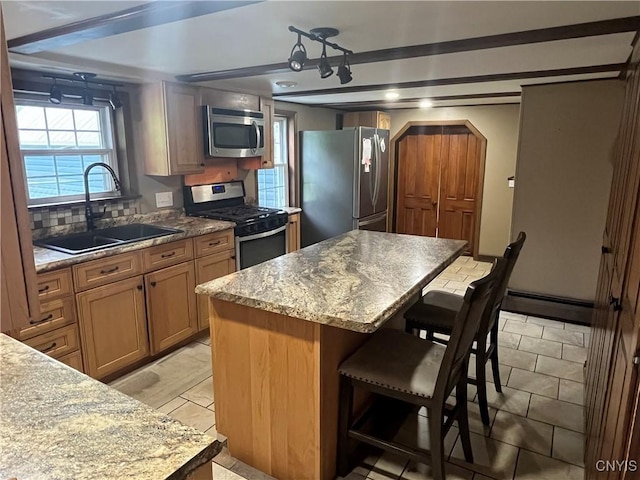 808 Fay, Bangor, NY 12966 - kitchen with stainless steel appliances, a sink, arched walkways, a kitchen island, and a baseboard radiator