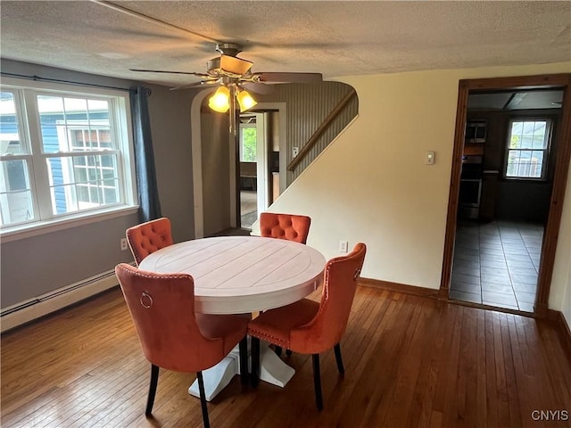 808 Fay, Bangor, NY 12966 - dining room featuring wood-type flooring, healthy amount of natural light, a textured ceiling, baseboards, and ceiling fan