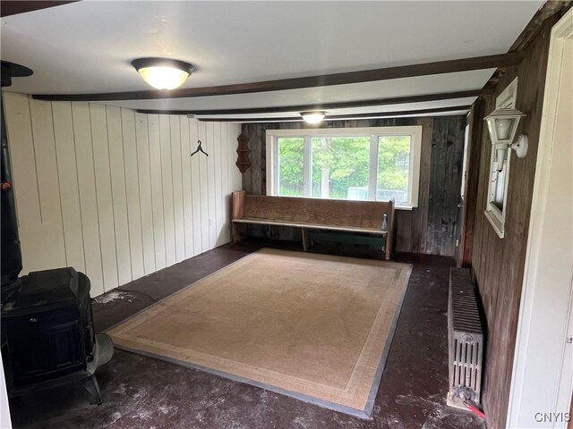 808 Fay, Bangor, NY 12966 - misc room featuring wooden walls, radiator, and concrete flooring