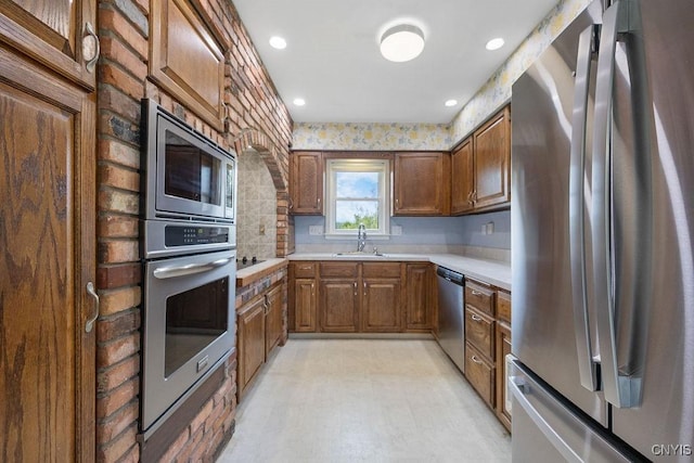 7739 Number 5 W Rd, Pompey, NY 13063 - kitchen with stainless steel appliances, light countertops, a sink, brown cabinets, and recessed lighting