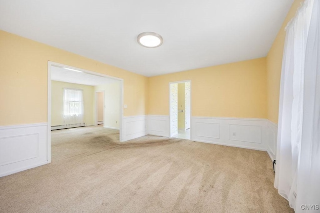 7739 Number 5 W Rd, Pompey, NY 13063 - carpeted empty room featuring wainscoting, a decorative wall, and a baseboard heating unit