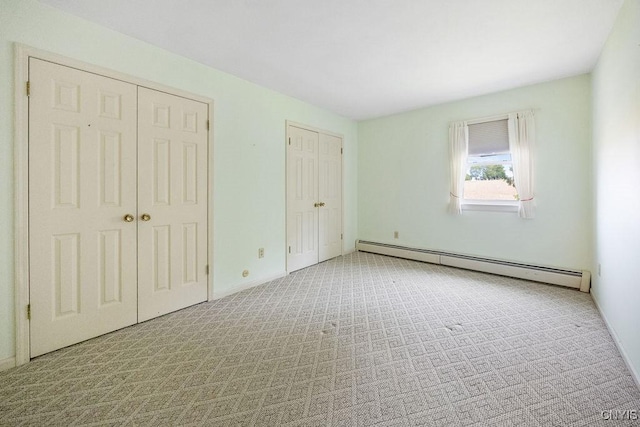 7739 Number 5 W Rd, Pompey, NY 13063 - unfurnished bedroom featuring a baseboard heating unit, carpet floors, baseboards, and multiple closets