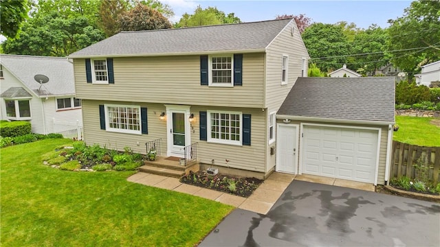 193 Floral Dr, Irondequoit, NY 14617 - colonial house featuring an attached garage and asphalt driveway