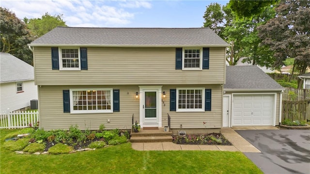 193 Floral Dr, Irondequoit, NY 14617 - colonial-style house featuring driveway, an attached garage, and central air condition unit