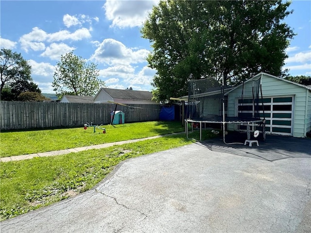 341 Grant St, Elmira-City, NY 14901 - view of yard with a trampoline, asphalt driveway, and an outbuilding