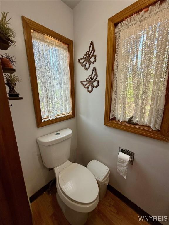 4545 Lower River Rd, Lewiston, NY 14092 - half bath featuring wood finished floors, toilet, and baseboards