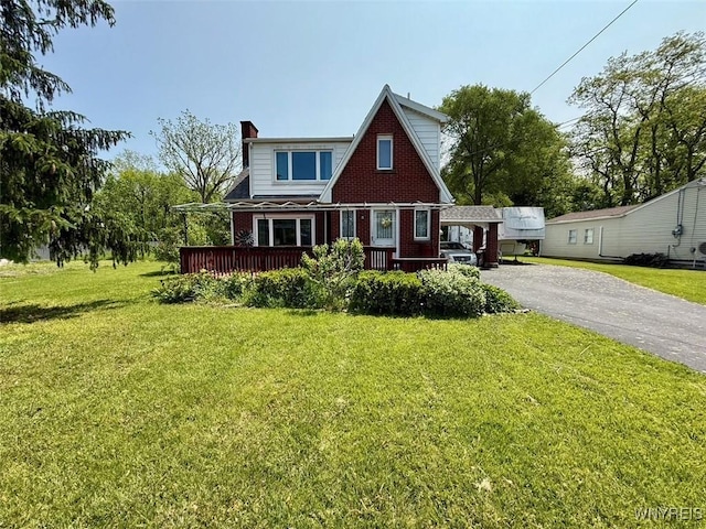 4545 Lower River Rd, Lewiston, NY 14092 - view of front of property with brick siding, a chimney, a front lawn, and driveway