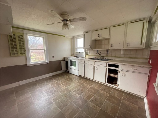 6235 E Avon Lima Rd, Avon, NY 14414 - kitchen featuring white range with electric cooktop, baseboards, a ceiling fan, light countertops, and a sink